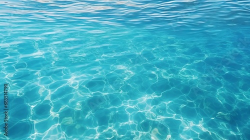 The serene and vibrant turquoise-colored deep ocean water with gentle ripples glistening under the bright sunshine on a typical summer day in a tropical country. photo