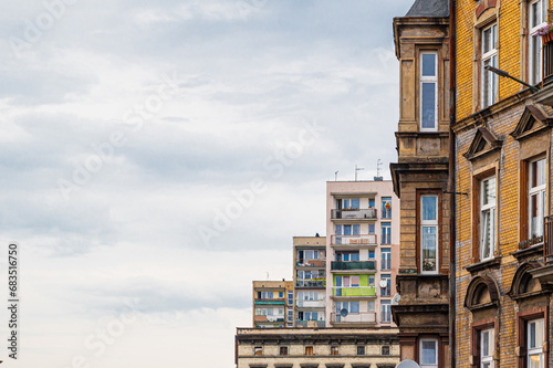 Historic and post-war residential building facades in Bytom, Poland. Architectural contrast between pre-war and communist-era housing styles in a Silesian city.