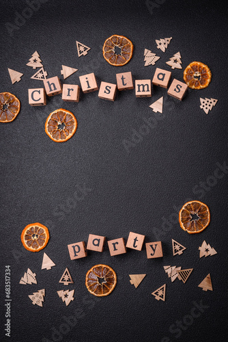 Christmas party inscription with wooden cubes on a dark concrete background
