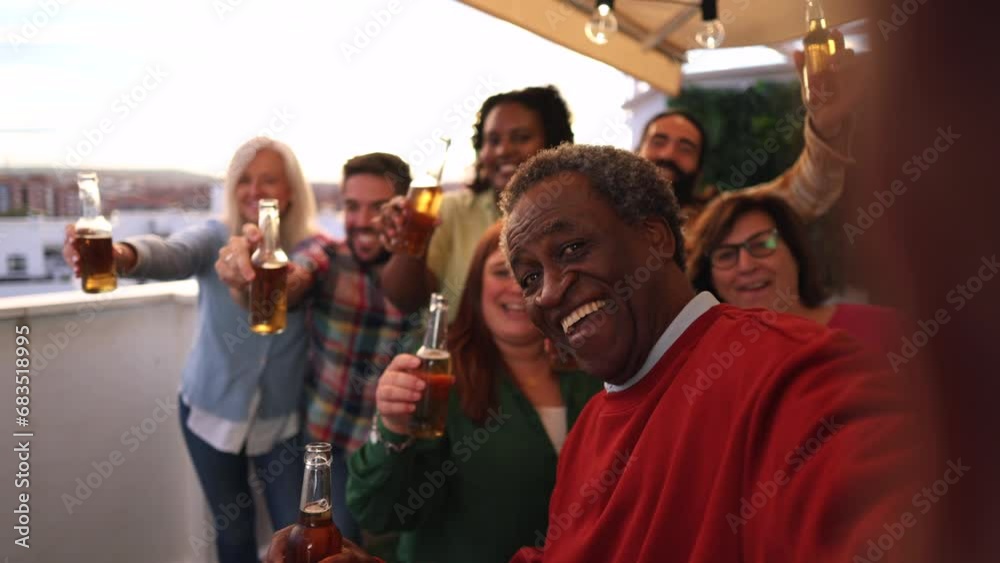 group of multiracial friends of different generations celebrating rooftop party with beer - social media selfie -