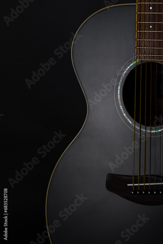 Classic acoustic guitar close up isolated on black background