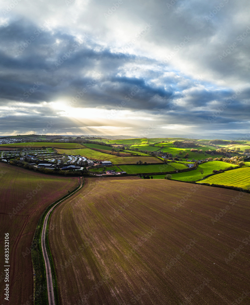 Panorama of Lights and Shadows over Fields and Farms from a drone, Devon, England, Europe