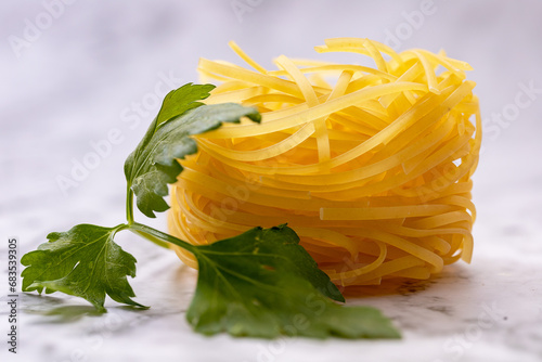 Homemade pasta pasta and parsley leaves close-up photo