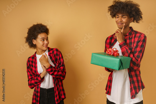 Happy and joyful couple exchange present for Christmas