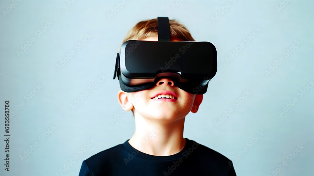 Boy wearing virtual reality glasses. Kid playing a virtual video game. Isolated on blue background. Boy wearing virtual reality glasses. Kid playing a virtual video game. Isolated on blue background.