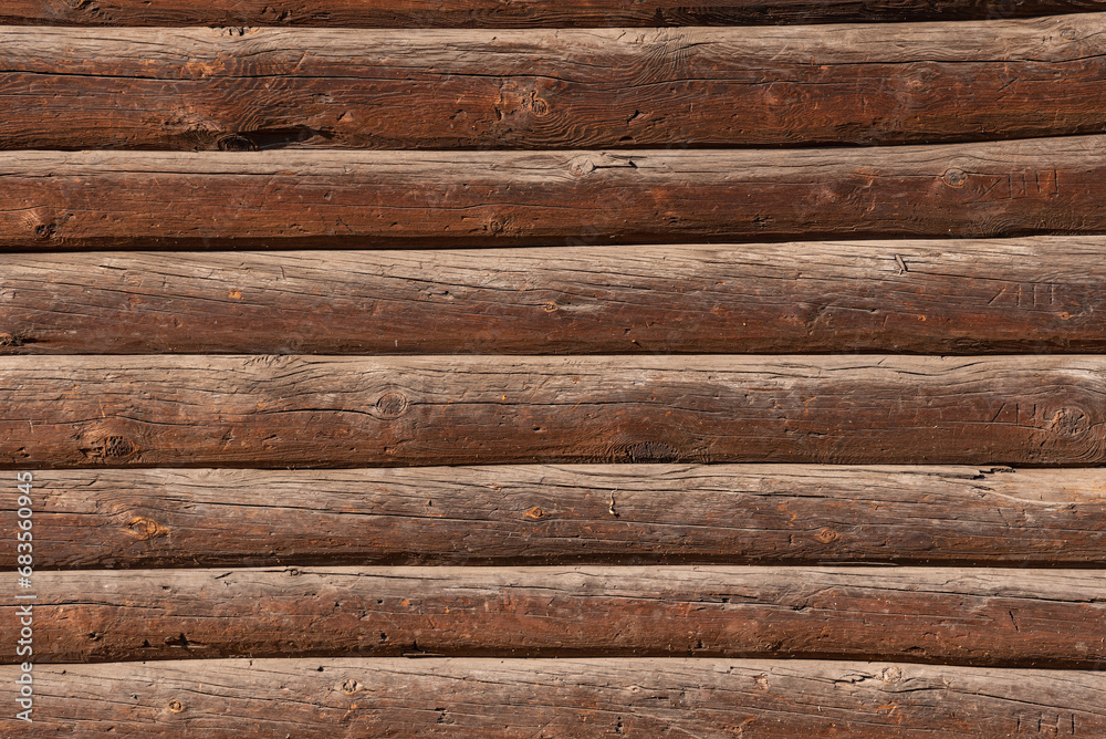 Wall surfaces made of brown wooden logs Wall surfaces made of brown wooden logs