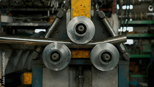 Industrial machine for cold metal pipe bending at industrial hall at manufacturing plant. Creative. Heavy industry concept.