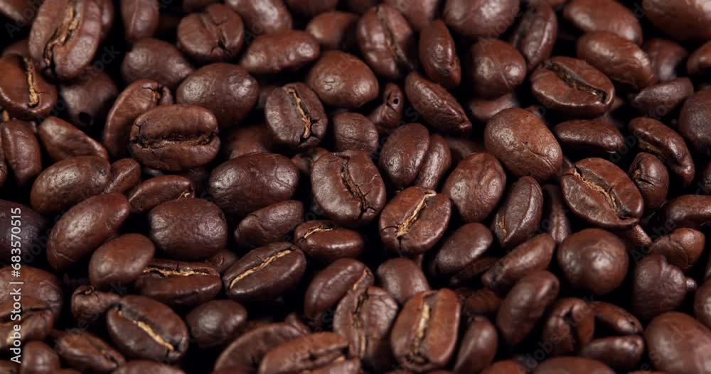 Close up of seeds of coffee. Fragrant coffee beans are roasted smoke comes from coffee beans. Close up of seeds of coffee. Fragrant coffee beans are roasted smoke comes from coffee beans.