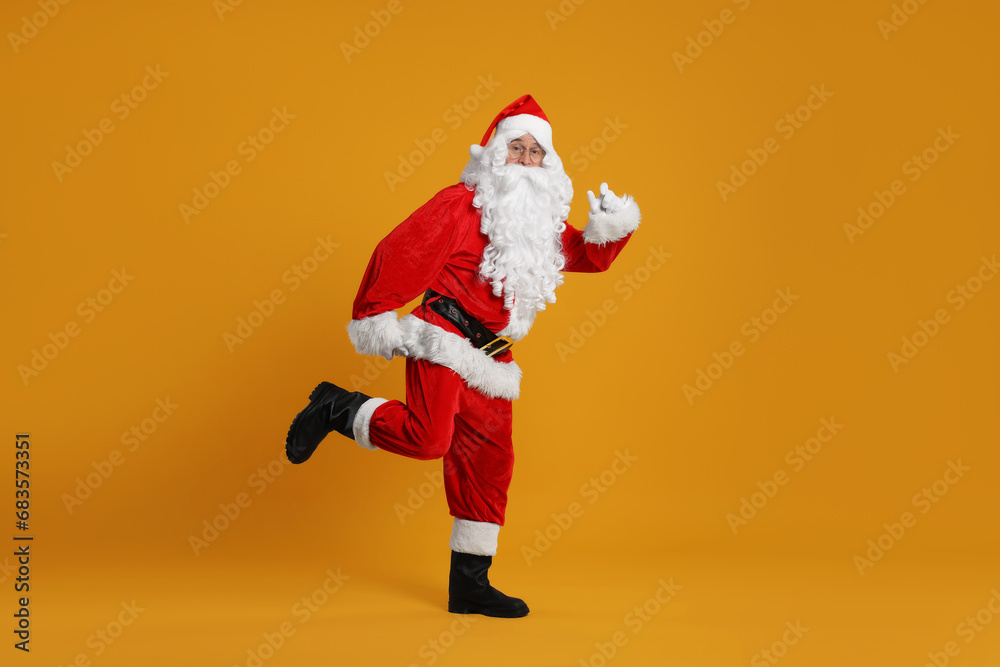 Merry Christmas. Santa Claus posing on orange background Merry Christmas. Santa Claus posing on orange background