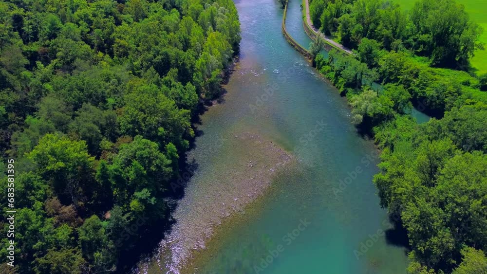 Trezzo sull'Adda, Italy. Aerial view of a mountain freshwater river with low water level surrounded by green trees. slaying. walks in the forest. Wild nature. Green Planet. Ecology. drone video Trezzo sull'Adda, Italy. Aerial view of a mountain freshwater river with low water level surrounded by green trees. slaying. walks in the forest. Wild nature. Green Planet. Ecology. drone video