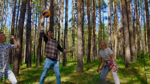 Friends have fun playing volleyball. Stock footage. Friends are emotionally playing volleyball. Vivid emotions of people from playing volleyball in nature