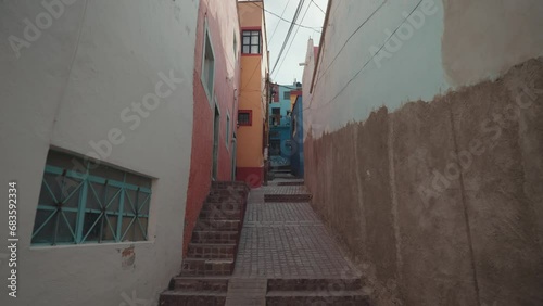 Walking on Small Narrow Street Alley with Colorful Buildings Guanajuato, Mexico photo