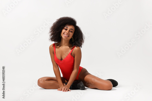 Beautiful woman in red one-piece summer swimsuit on white background © New Africa