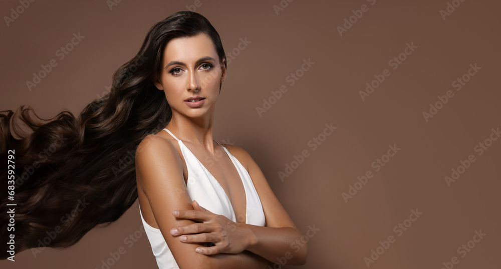Hair styling. Attractive woman with wavy long hair on brown background. Banner design with space for text