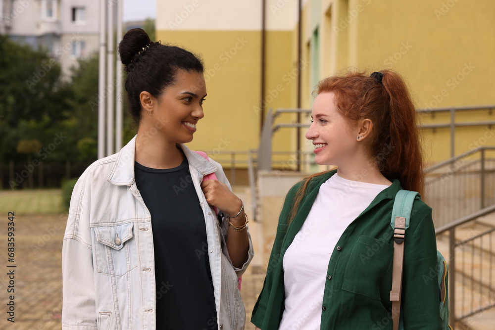 Happy young students spending time together outdoors Happy young students spending time together outdoors