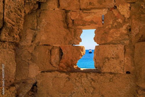 View of the yacht from the fortress wall of the island of Rhodes. Background with selective focus and copy space