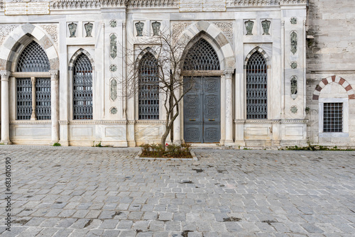 part wall of Bayezid mosque with antique windows - one of the oldest mosques in Istanbul photo