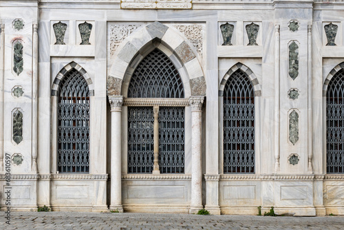 part wall of Bayezid mosque with antique windows - one of the oldest mosques in Istanbul photo