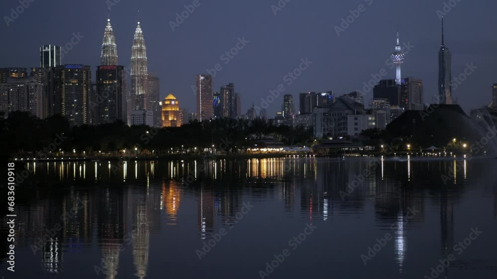 landscape view of kuala lumpur city center downtown district area with many skyscraper building highrise modern style towers over the lake pond