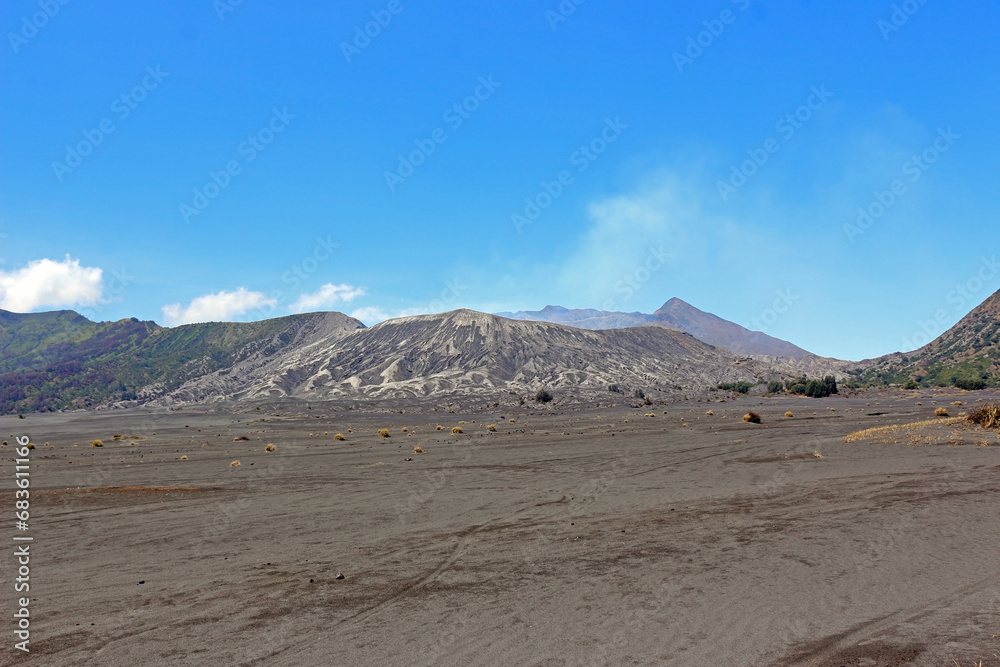 The desert an the crater of Mount Bromo under the blue sky.