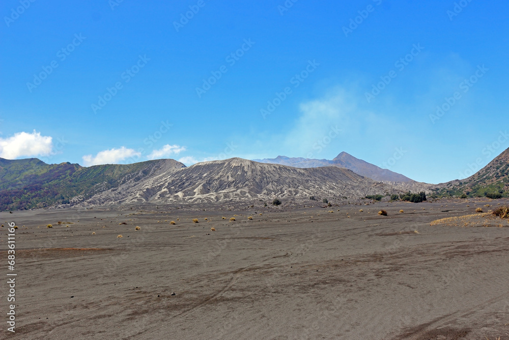 The desert an the crater of Mount Bromo under the blue sky. The desert an the crater of Mount Bromo under the blue sky.