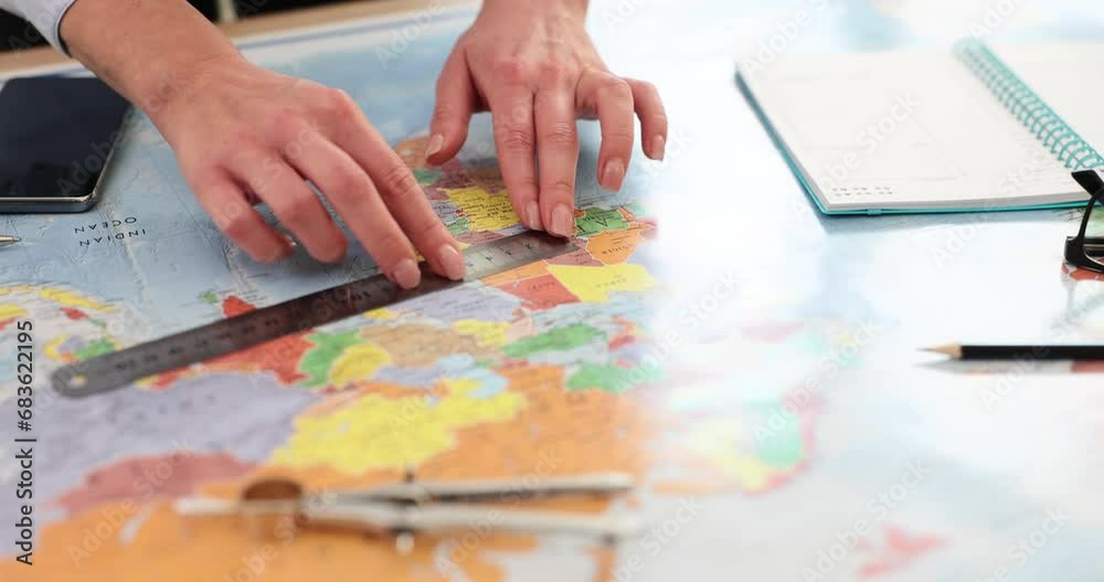 Female hands with ruler on world map Female hands with ruler on world map