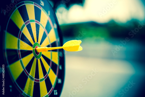 Bullseye target goal or dartboard has dart arrow throw hitting center shooting for financial business targeting planning to winner concept. photo
