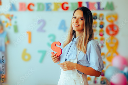 Speech Therapist Holds the Letter S in Her Hand. Professional logopedic expert teaching about sounds and pronunciation
 photo