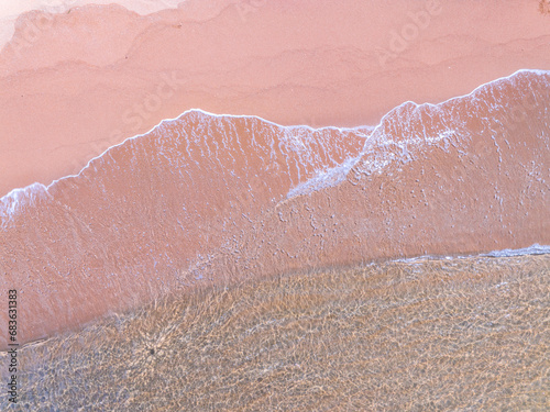 Aerial view of sea crashing waves White foaming waves on beach sand,Top view beach sea surface, Nature sea beach sand background