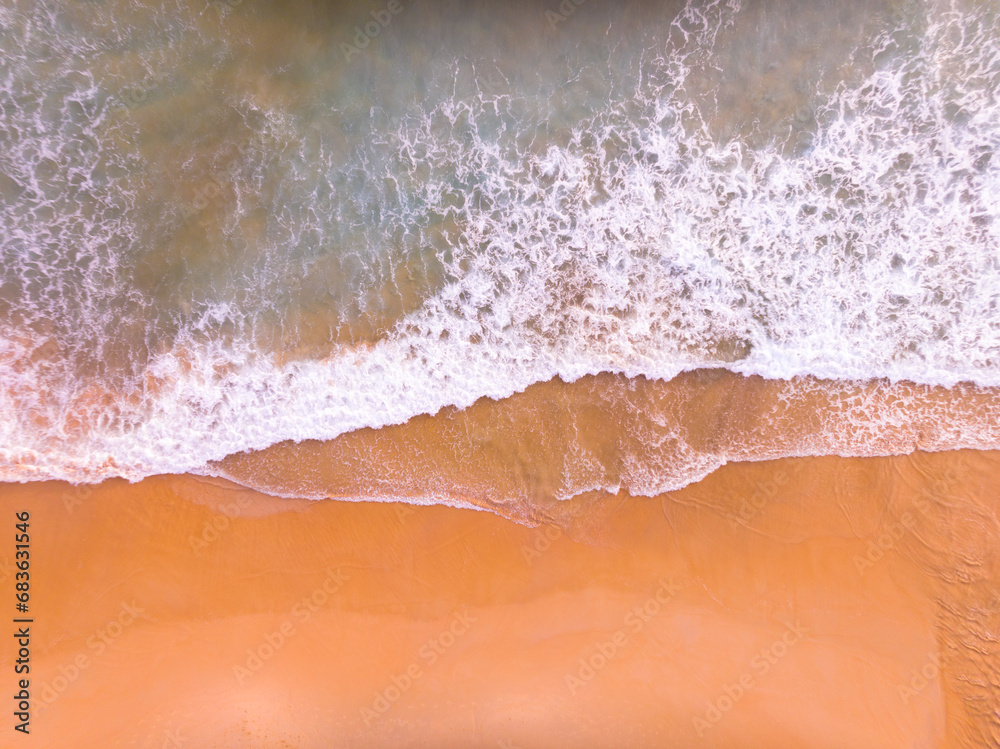 Aerial view of Waves crashing on sandy shore,Sea surface ocean waves background,Top view beach background
