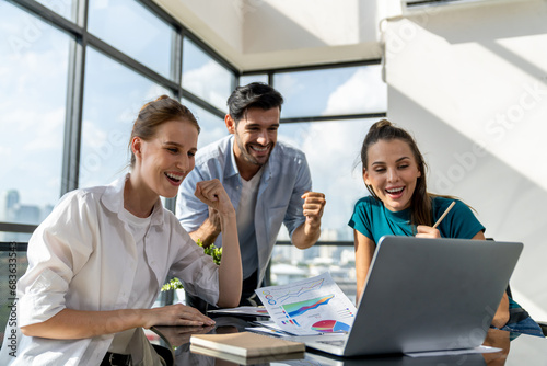 Group of happy businesspeople celebrate their successful project. Professional business team win and proud of their project at modern office. Successful teamwork, happy colleague, workplace. Tracery.