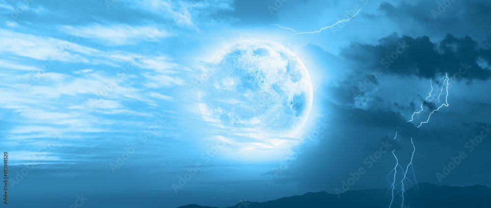 Fototapeta premium Lightning strikes between clouds with full moon at night 