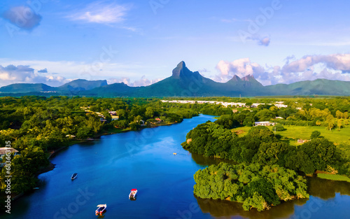 fishing boats resting at Tamarin Bay Mauritius island Indian Ocean Africa with Tamarin Mountain on the background at sunset. Tamarin Lagoon Mauritius
