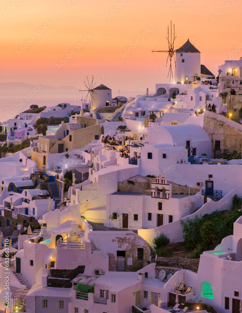 White churches an blue domes by the ocean of Oia Santorini Greece during sunset, a traditional Greek village in Santorini during summer in Europe