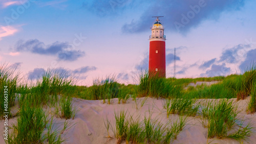 Texell lighthouse during sunset on the beach in the Netherlands Dutch Island Texel in summer with sand dunes at the Wadden Island photo