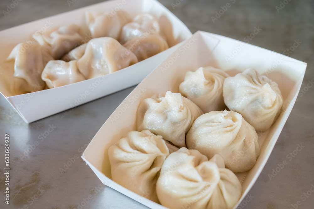 Steamed pork meat soup bun in the take away box Steamed pork meat soup bun in the take away box