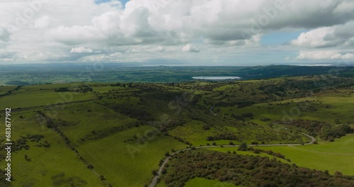 Epic bird's-eye view of vast green Mendip Hills and scenic landscapes of Cheddar village and Cheddar Reservoir photo