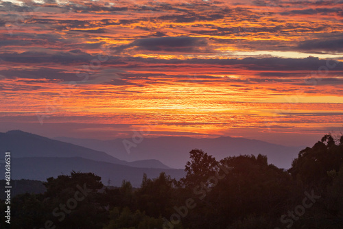 Amazing colorful sunrise sky over the rainforest mountains at Ob Luang natinoal park, Chiangmai, Thailand photo