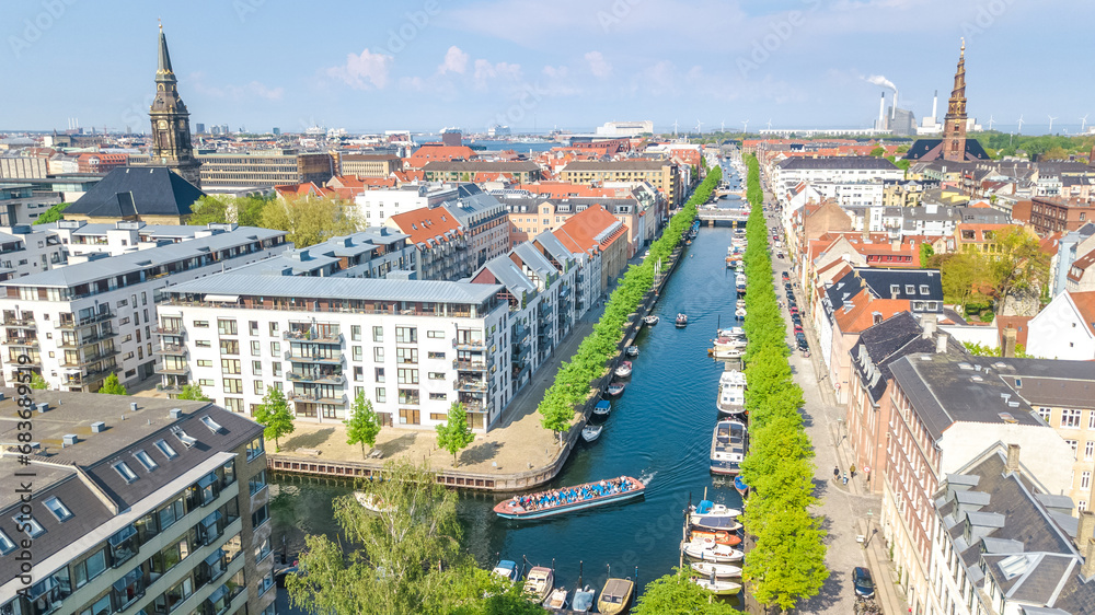 Copenhagen skyline aerial drone view from above, Nyhavn historical pier port and canal with color buildings and boats in the old town of Copenhagen, Denmark
