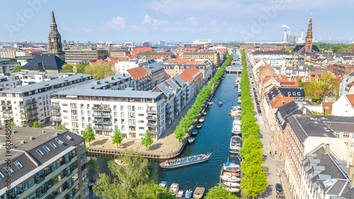 Copenhagen skyline aerial drone view from above, Nyhavn historical pier port and canal with color buildings and boats in the old town of Copenhagen, Denmark 