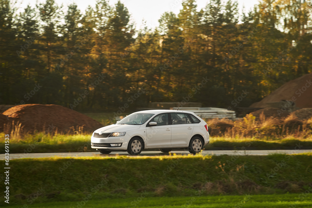 A modern sporty station wagon car on the highway. Practical and elegant car. Universal body estate car on the road. Combi car with C and D pillar and big trunk. A modern sporty station wagon car on the highway. Practical and elegant car. Universal body estate car on the road. Combi car with C and D pillar and big trunk.