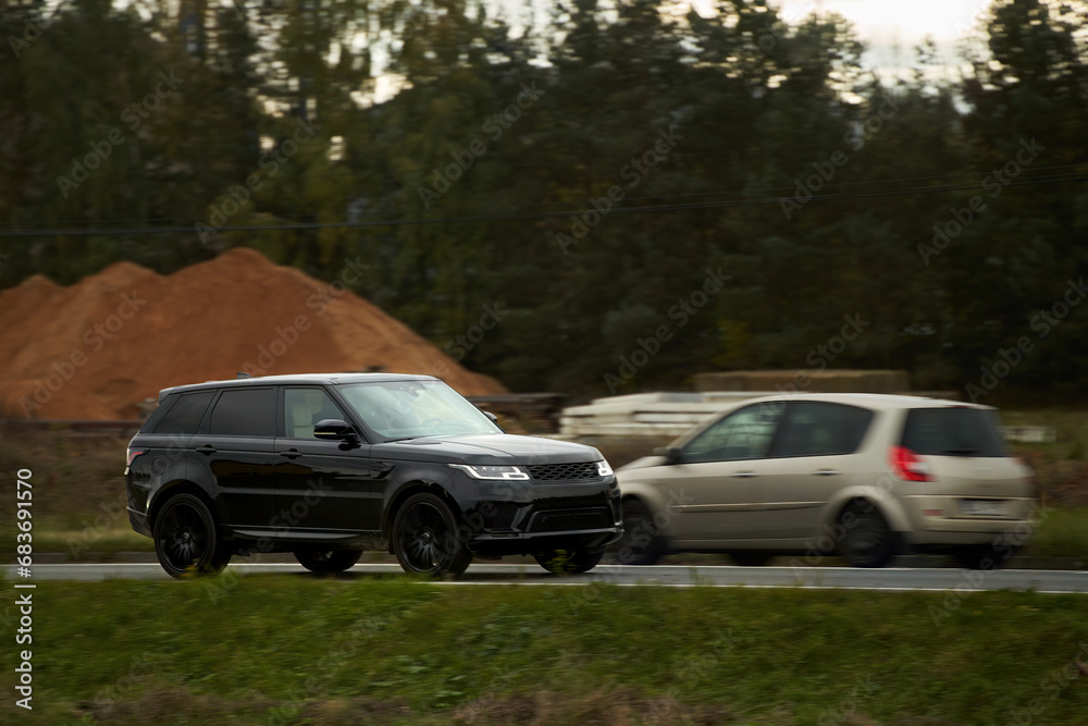 Black SUV Car Isolated on the highway road. Sporty luxury crossover on the interstate. Black SUV Car Isolated on the highway road. Sporty luxury crossover on the interstate.