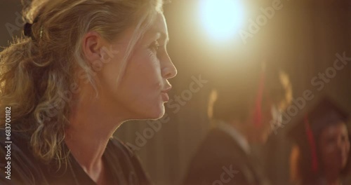 Female professor congratulating college or university graduates on stage photo