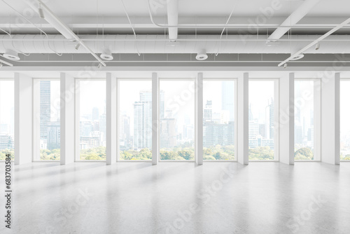 Stylish empty office interior with light concrete floor and panoramic window photo