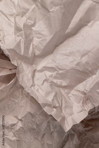 gray low-quality crumpled paper from recycled waste paper