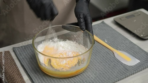 Baker mixing flour, butter, sugar and egg for making choux cream dough