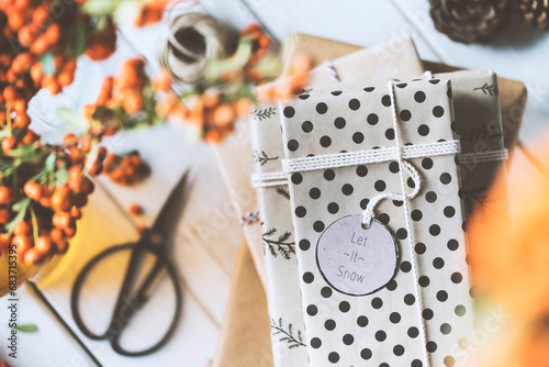 Christmas gift box stack on wooden table, let it snow photo