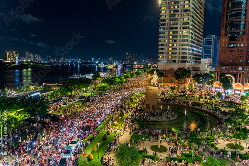 View of Me Linh roundabout with heavy traffic near Bach Dang waterbus station port and Saigon river at blue hour