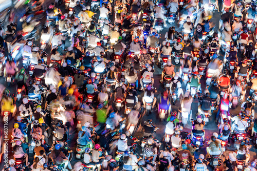 View of Me Linh roundabout with heavy traffic near Bach Dang waterbus station port and Saigon river at blue hour