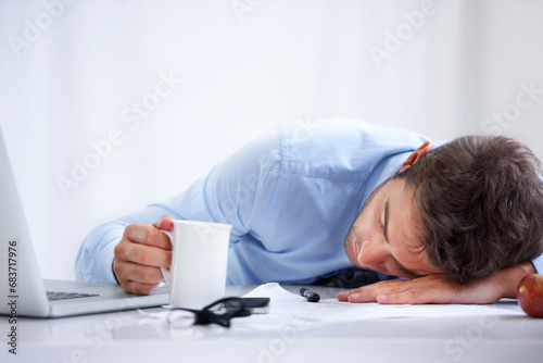 Business man, sleeping and tired at work, burnout and exhausted or mental health, desk and overwhelmed. Male person, dreaming and lazy in office, resting and fatigue or low energy, coffee and nap